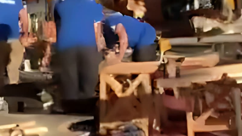 The same crop after the AI upscaler: cleaner edges on the wood and clothing, fewer compression blocks